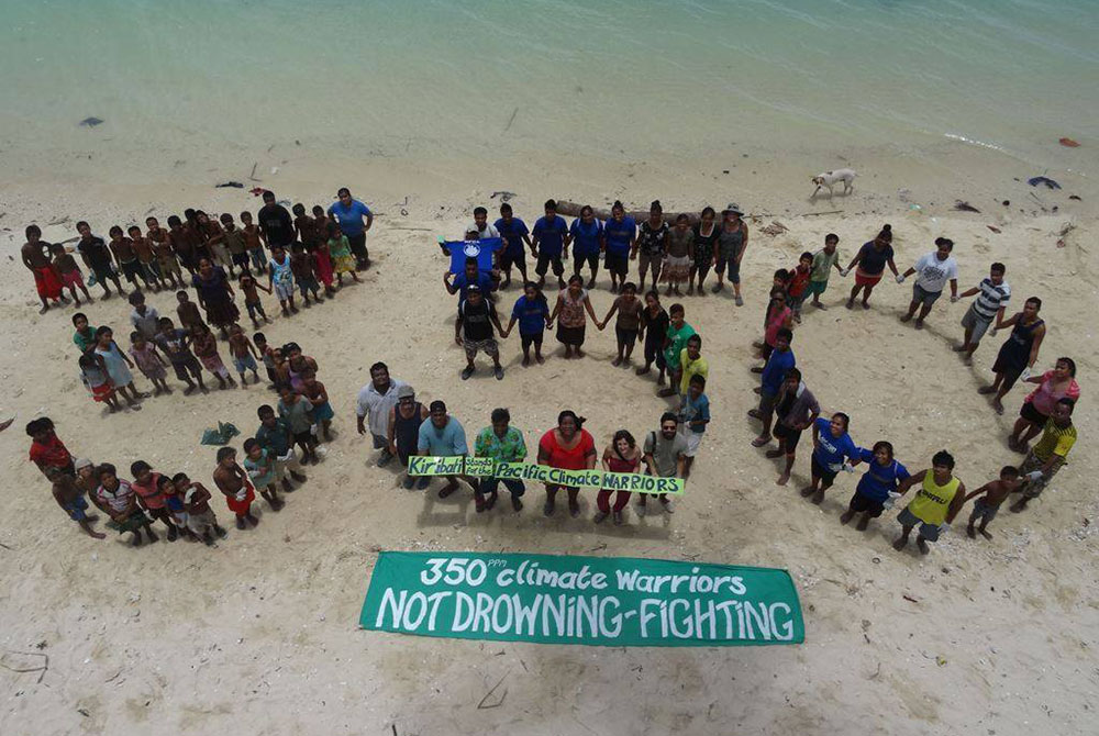 Members of the Pacific Climate Warriors on the island of Kiribati form the number 350, a number representing the safe maximum level of carbon dioxide in the atmosphere. (Courtesy of Pacific Climate Warriors) Members of the Pacific Climate Warriors on the island of Kiribati form the number 350, a number representing the safe maximum level of carbon dioxide in the atmosphere. (Courtesy of Pacific Climate Warriors)