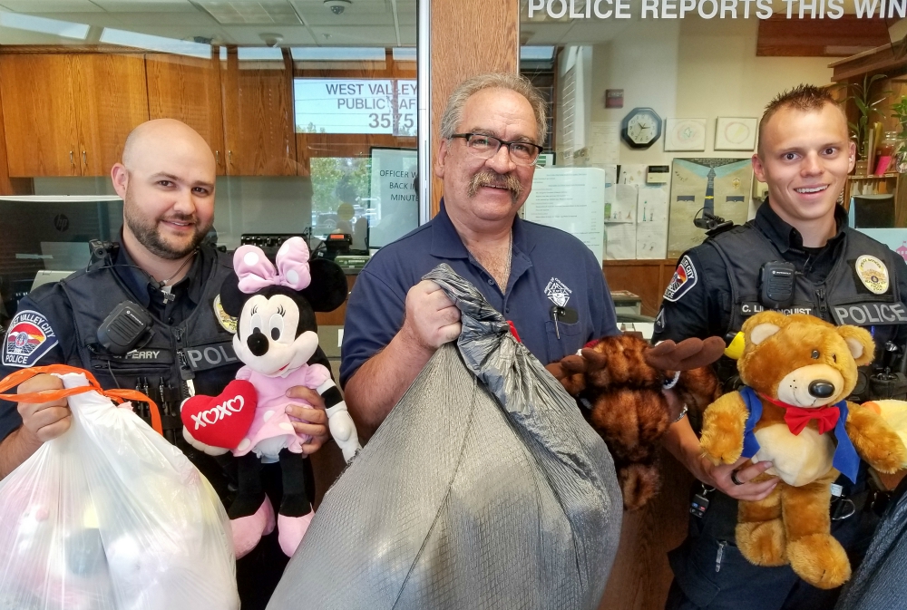 Utah Knights of Columbus 4th Degree District Marshall Richard Vigor, center, is flanked by members of the West Valley City Police Department following the Knights’ collection drive for stuffed animals for traumatized children. (Courtesy of Andy Airriess)