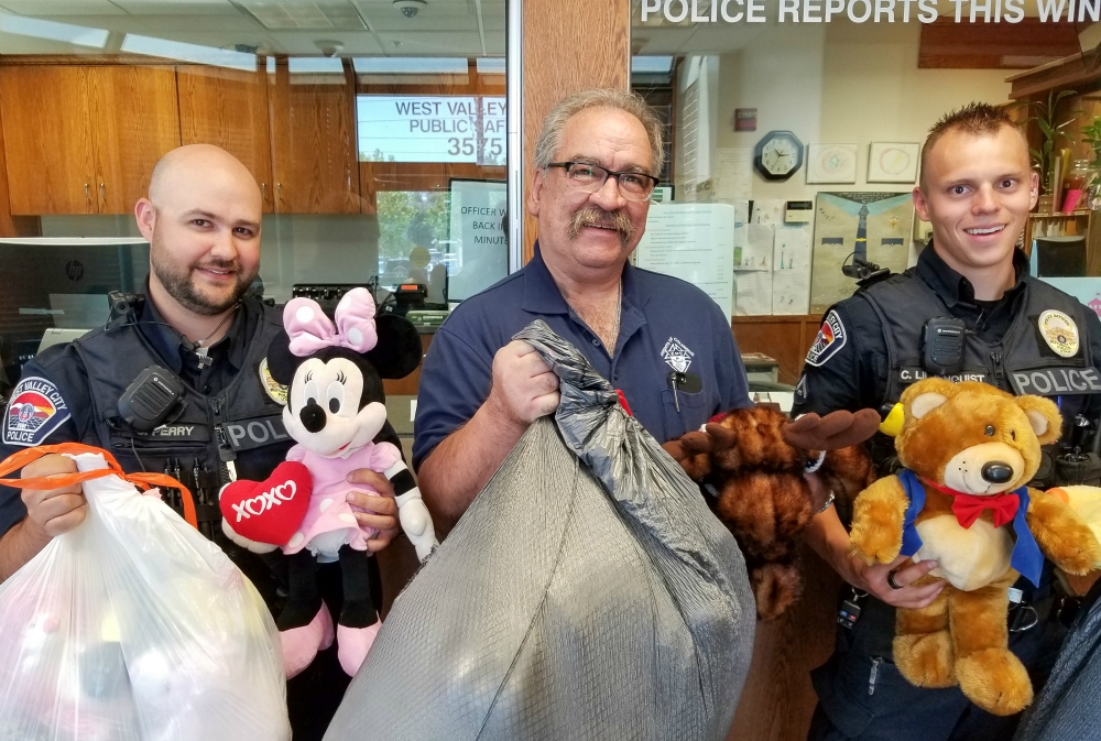 Utah Knights of Columbus 4th Degree District Marshall Richard Vigor, center, is flanked by members of the West Valley City Police Department following the Knights’ collection drive for stuffed animals for traumatized children. (Courtesy of Andy Airriess) Utah Knights of Columbus 4th Degree District Marshall Richard Vigor, center, is flanked by members of the West Valley City Police Department following the Knights’ collection drive for stuffed animals for traumatized children. (Courtesy of Andy Airriess)
