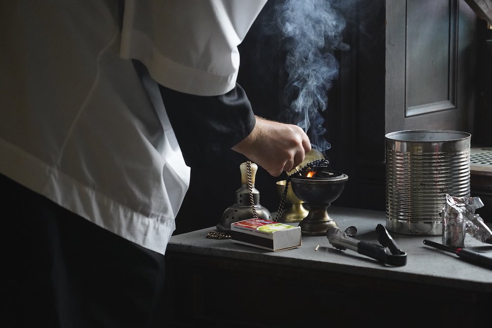 An altar server prepares a censer for use during a traditional Latin Mass July 1, at Immaculate Conception Seminary in Huntington, New York. (CNS/Gregory A. Shemitz)