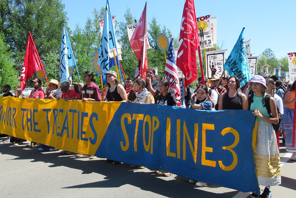 Line 3 protest During a protest against the Enbridge Line 3 pipeline June 7, demonstrators march along a highway to call for treaty rights to be honored. (Claire Schaeffer-Duffy)