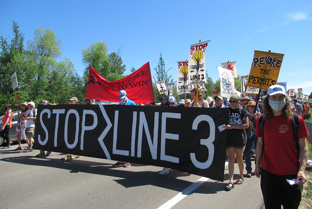During a protest against the Enbridge Line 3 pipeline June 7, demonstrators march along a highway to call for treaty rights to be honored. (Claire Schaeffer-Duffy)