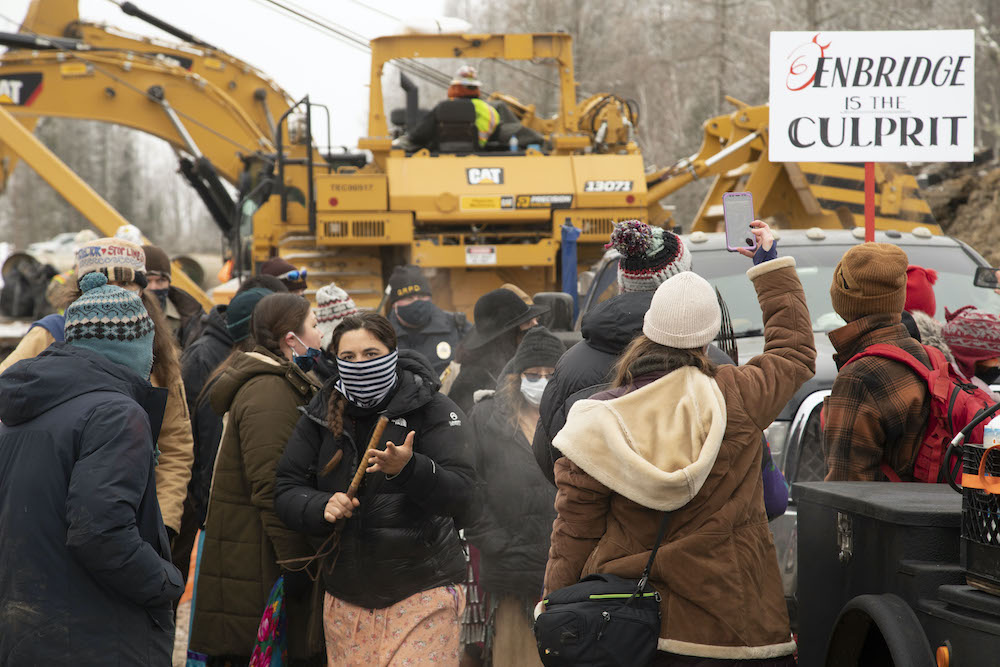 Protesters surround construction equipment used to drill a path for the Enbridge Line 3 oil pipeline near Haypoint, Minnesota, Jan. 9, 2021. (© Keri Pickett)