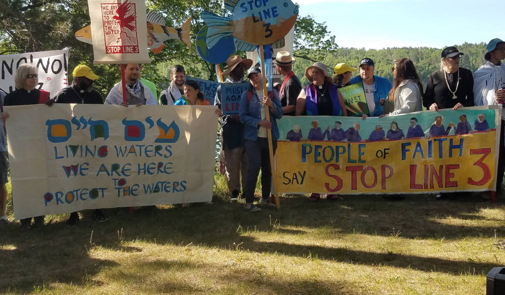 A multi-faith delegation prays before a march and rally opposing the Enbridge Line 3 pipeline near the Mississippi headwaters in northern Minnesota in early June. (Marianne Comfort)