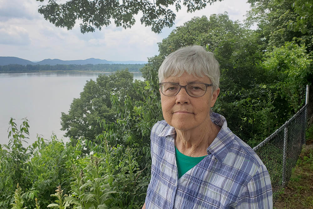 Dominican Sr. Bette Ann Jaster stands on part of the Mariandale property overlooking the Hudson River. (EarthBeat photo/Chris Herlinger)