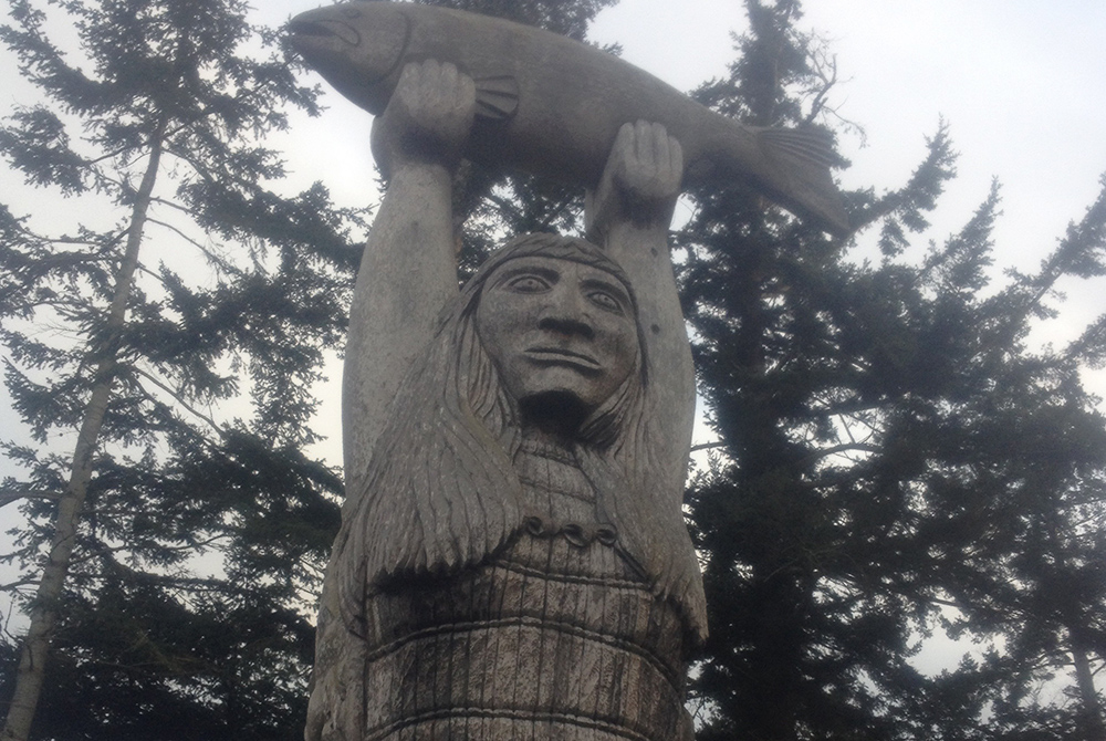 A totem called "Ko-kual-alwoot" ("Maiden of the Sea"), carved by a Swinomish tribal member, stands near Deception Pass at Rosario Beach on the coast of Puget Sound, a few miles from the Suquamish Reservation. (Courtesy of The Cedar Tree Institute)