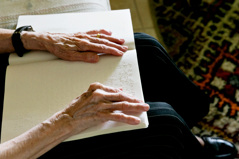 Cuban-American Adelina Maideski reads Braille Catholic materials in early May at her residence in Coconut Creek, Florida. (CNS/Tom Tracy) 