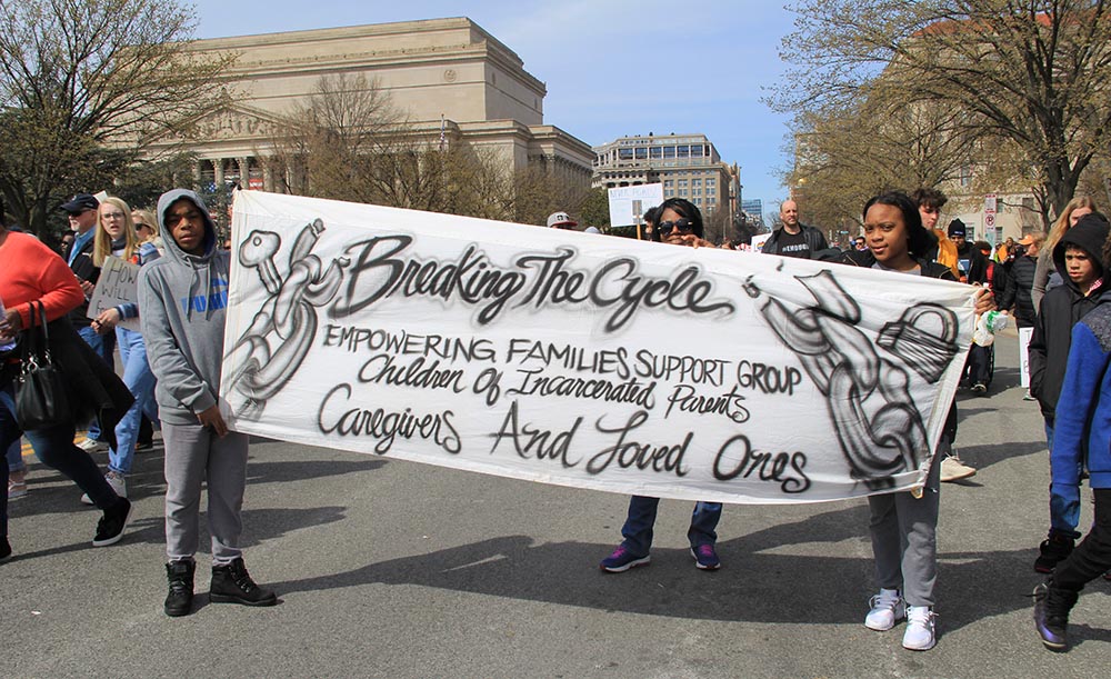Young activists carry a banner for children of incarcerated parents during the March for Our Lives in Washington, D.C., on March 24, 2018. (Wikimedia Commons/Ziggyfan23)