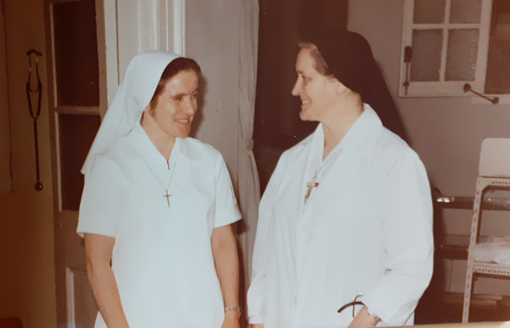 In 1978, Columban Sr. Mary Greaney, left, speaks to Columban Sr. Mary Aquinas Monaghan, who was the medical director at Ruttonjee Sanatorium for almost 40 years.