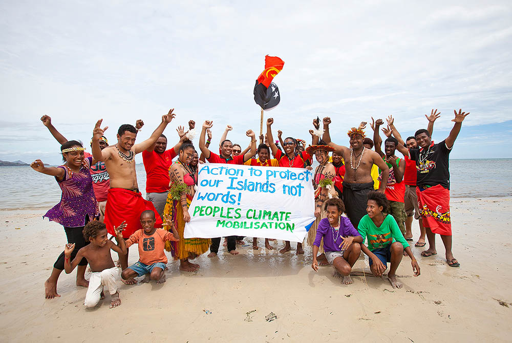 Members of the Pacific Climate Warriors in Papua New Guinea pose during an event. (Courtesy of Pacific Climate Warriors) Members of the Pacific Climate Warriors in Papua New Guinea pose during an event. (Courtesy of Pacific Climate Warriors)