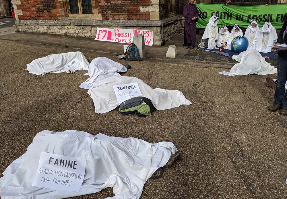 Members of the Christian Climate Action group demonstrate Oct. 17 outside Lambeth Palace, the Anglican archbishop of Canterbury's London residence, demanding an end to the Church of England's fossil fuel investments. (Courtesy of Christian Climate Action)