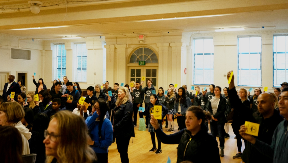 Parents and others gather April 4 at Star of the Sea School auditorium in San Francisco to show support for faculty members who have served the school, which will suspend classes at the end of the school year. (Courtesy of anonymous parent)