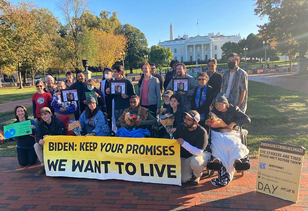 Participants in the All Saints' Day solidarity fast organized by Catholic Climate Covenant and the Ignatian Solidarity Network visit climate hunger strikers outside the White House in Washington, D.C. (Courtesy of Josh Burg)