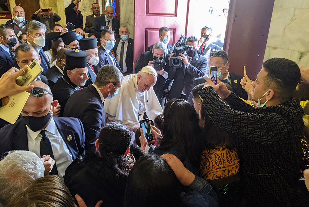 Pope Francis blesses a child amid a crowd of local Syriacs March 7 at the Church of the Immaculate Conception in Qaraqosh, the largest Catholic Church in Iraq. (Xavier Bisits)