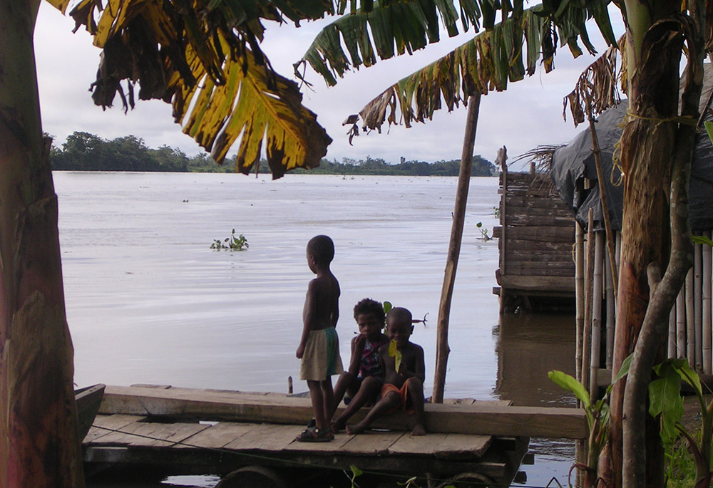 A child looks out on the Atrato River in the Chocó region of Colombia. (Courtesy of ABColombia) A child looks out on the Atrato River in the Chocó region of Colombia. (Courtesy of ABColombia)