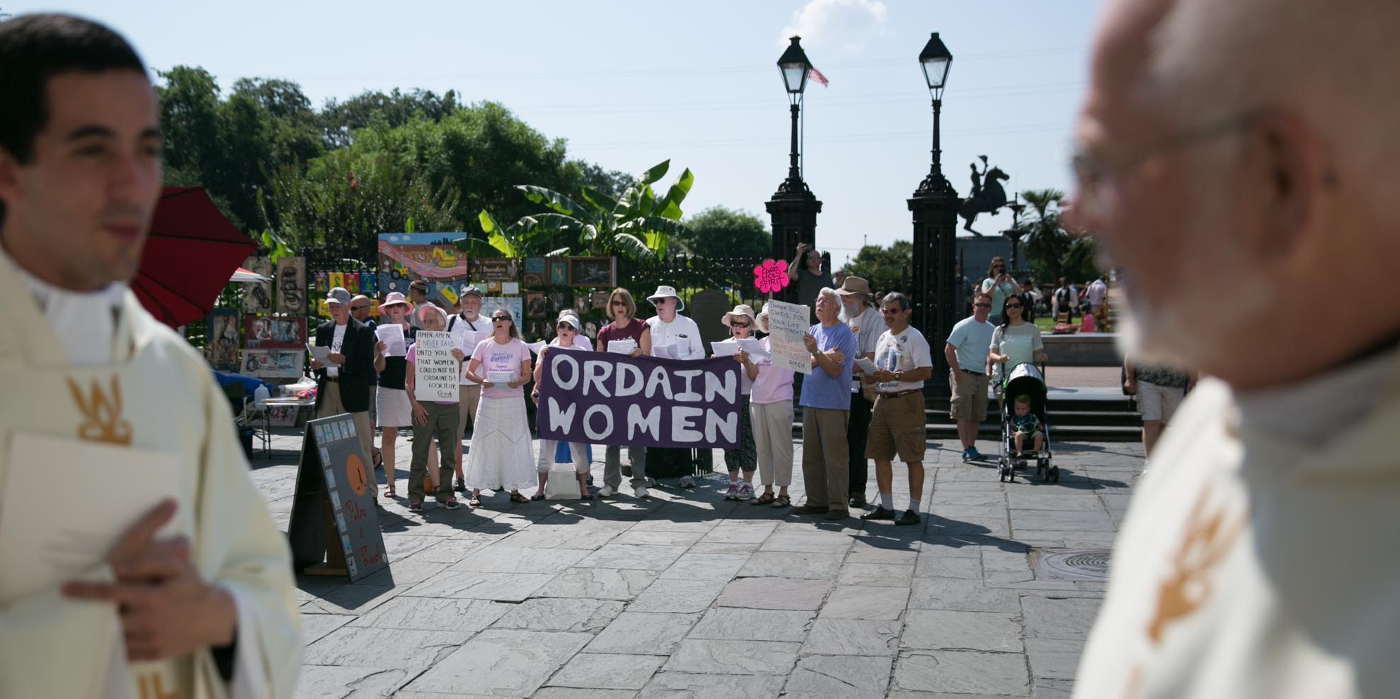 Supporters of women's ordination gather in Jackson Square in New Orleans outside the St. Louis Cathedral during the archdiocese's ordination ceremony for new priests in June 2015.