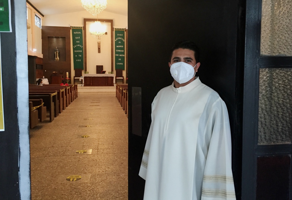 Fr. Emiliano Quezada poses for a photo at the St. Martin de Porres Parish in Reynosa, Mexico, where the coronavirus pandemic closed factories and left thousands unemployed. Quezada has taken on duties as a chaplain in COVID-19 wards. (David Agren) Fr. Emiliano Quezada poses for a photo at the St. Martin de Porres Parish in Reynosa, Mexico, where the coronavirus pandemic closed factories and left thousands unemployed. Quezada has taken on duties as a chaplain in COVID-19 wards. (David Agren)
