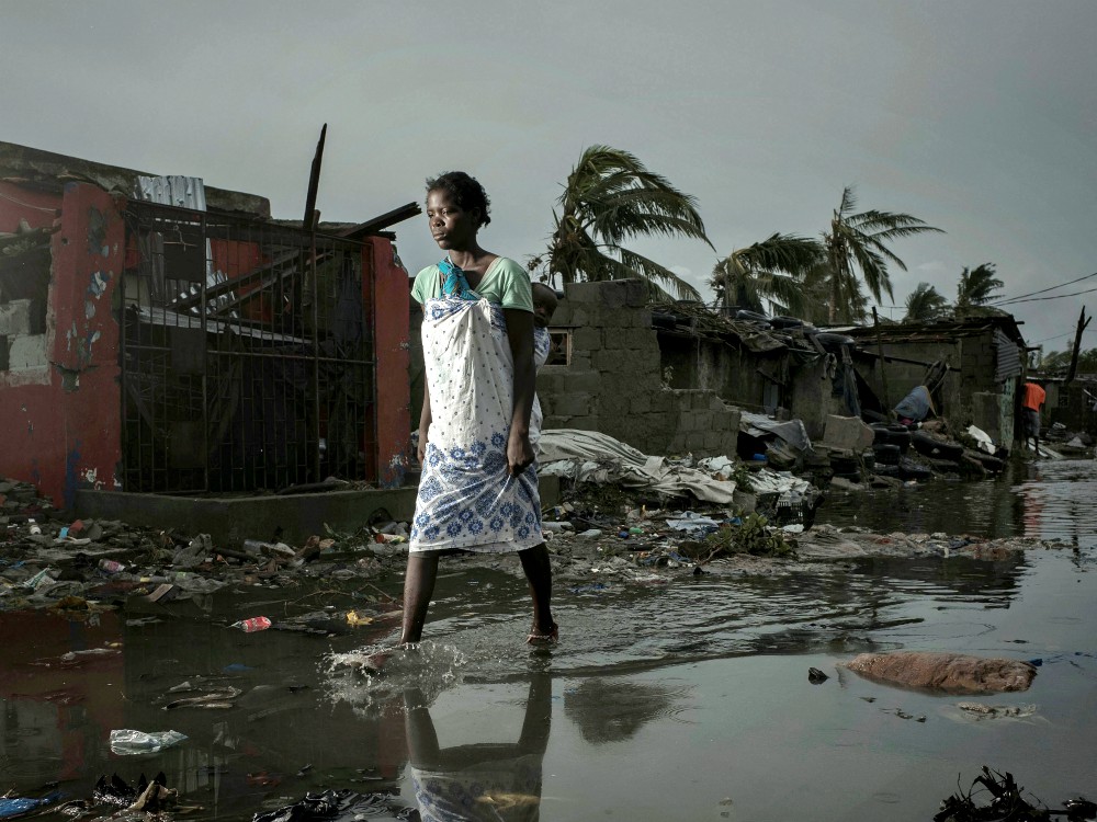 A young woman walks through floodwaters March 17 in the aftermath of Cyclone Idai in Beira, Mozambique. More than 600 died in Mozambique after a cyclone slammed into the country, submerging entire villages. (CNS/Reuters/Care International/Josh Estey)