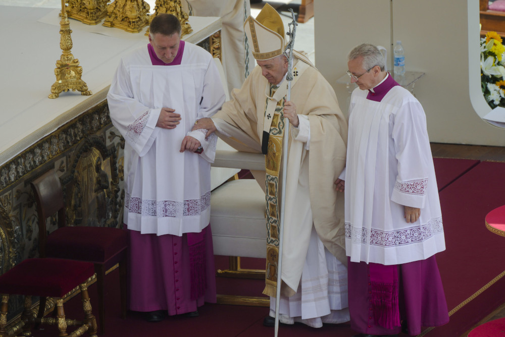 Pope Francis is helped walking as he celebrates the canonization Mass for 10 new saints in St. Peter's Square at the Vatican May 15. (AP/Gregorio Borgia)