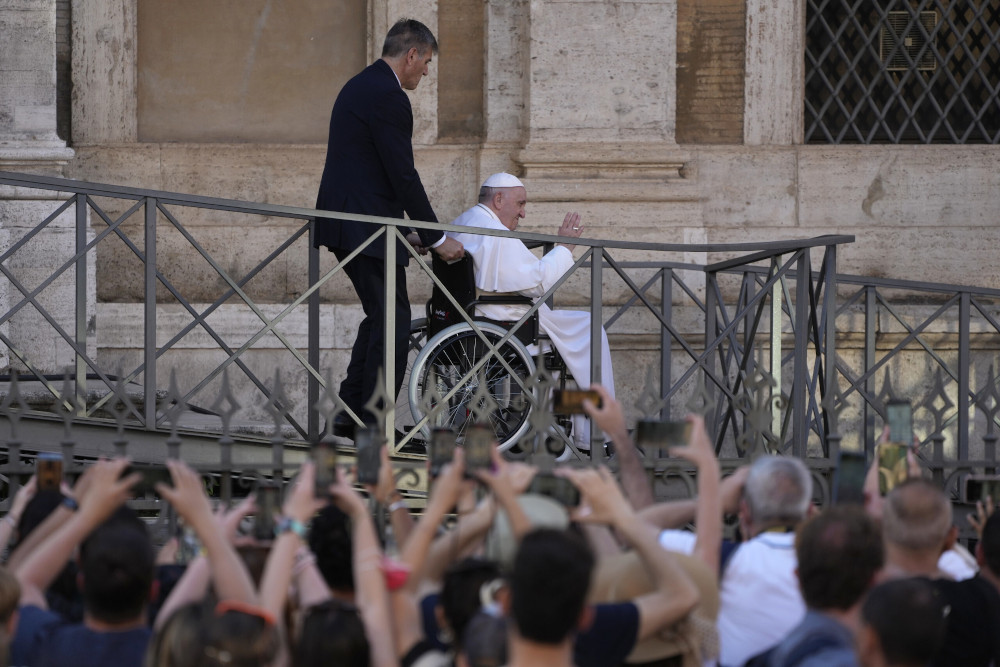 Pope Francis greets the faithful as he leaves St. Mary Major Basilica after participating in a rosary prayer for peace in Rome May 31. (AP/Gregorio Borgia)