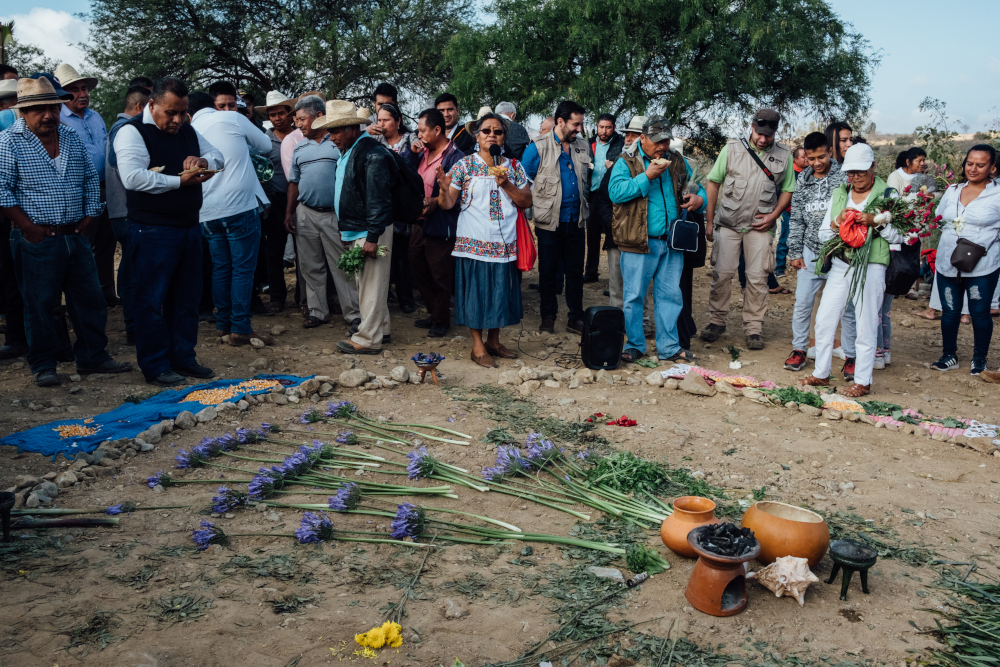 Carmen Santiago Alonso, center, speaks over a loudspeaker during an event celebrating World Water Day in 2019. Alonso often held events to remind people to give thanks to Mother Earth. (RNS/Noel Rojo)