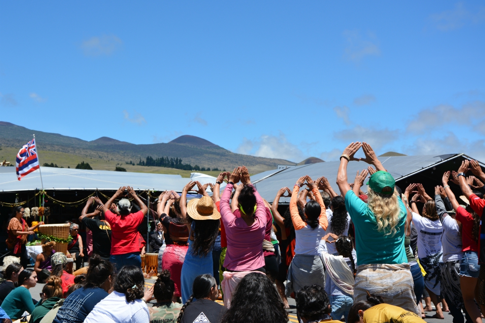 Protectors who oppose the construction of the Thirty Meter Telescope perform traditional Hawaiian dances at the base of Mauna Kea in Hawaii. (RNS/Jack Jenkins)