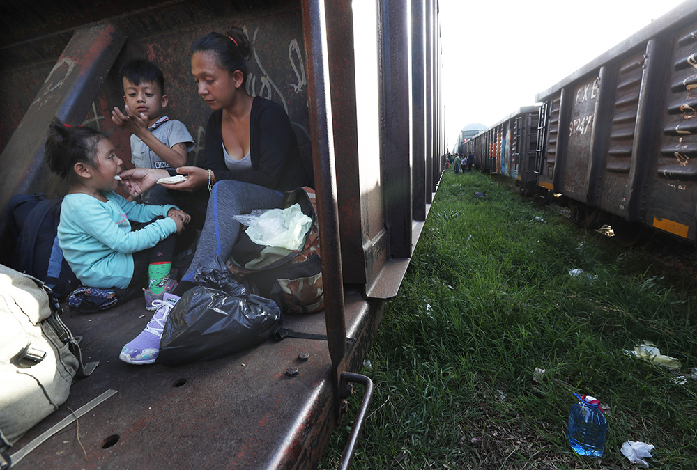 A migrant mother and children ride a freight train on their journey north, on June 24, 2019, in Palenque, Chiapas state, Mexico. (RNS/AP photo/Marco Ugarte)