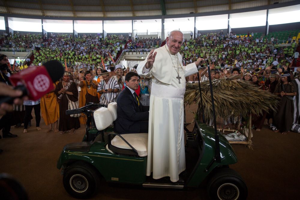 Pope Francis waves from a golf cart as he is driven inside a coliseum during a meeting with indigenous groups from the Peruvian Amazon, in Puerto Maldonado, Madre de Dios province, Peru, Jan. 19, 2018. (AP/Rodrigo Abd)