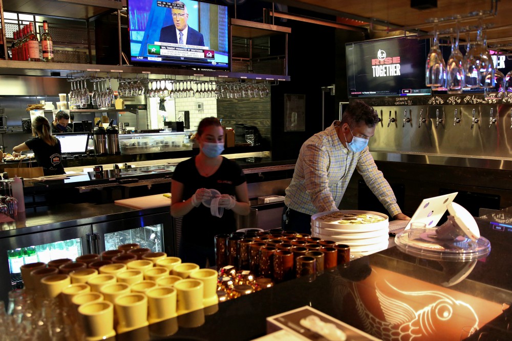 People in Miami work at a restaurant Aug. 31 during the coronavirus pandemic. (CNS/Reuters/Marco Bello) People in Miami work at a restaurant Aug. 31 during the coronavirus pandemic. (CNS/Reuters/Marco Bello)