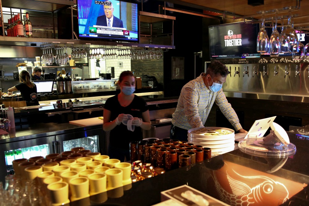 People in Miami work at a restaurant Aug. 31 during the coronavirus pandemic. (CNS/Reuters/Marco Bello)