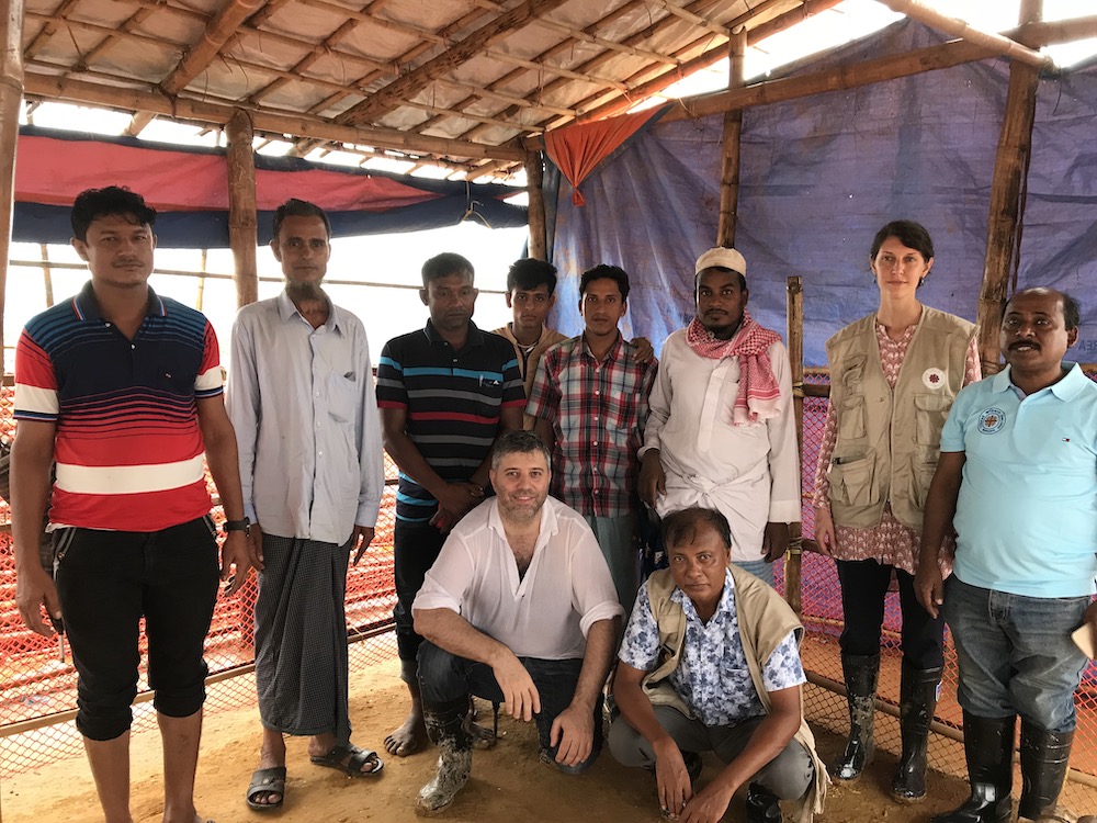 Film director Evgeny Afineevsky, at center, poses with several members of the Rohingya minority community who met Pope Francis in Bangladesh in 2017 and are featured in the film "Francesco" (Provided photo)
