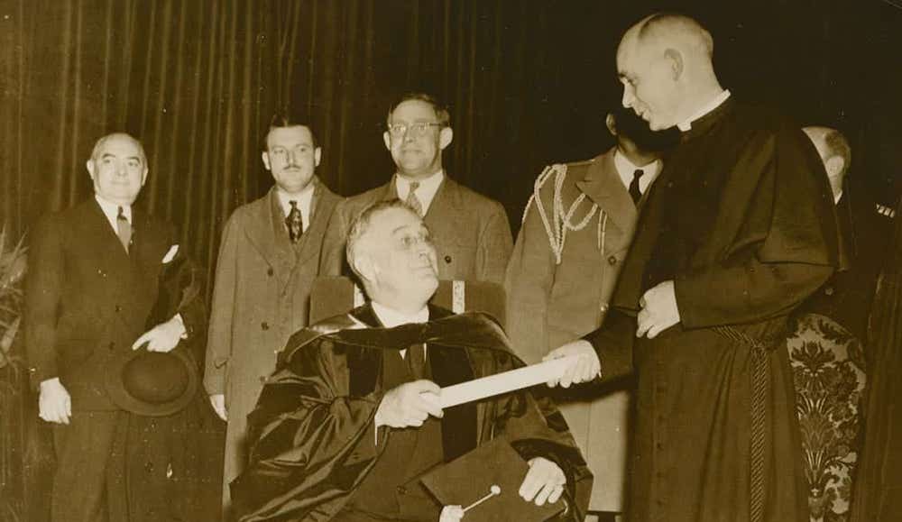 President Franklin D. Roosevelt, left, receives an honorary degree from University of Notre Dame President Holy Cross Fr. John F. O'Hara at a special convocation in December 1935. (Courtesy of University of Notre Dame Archives)