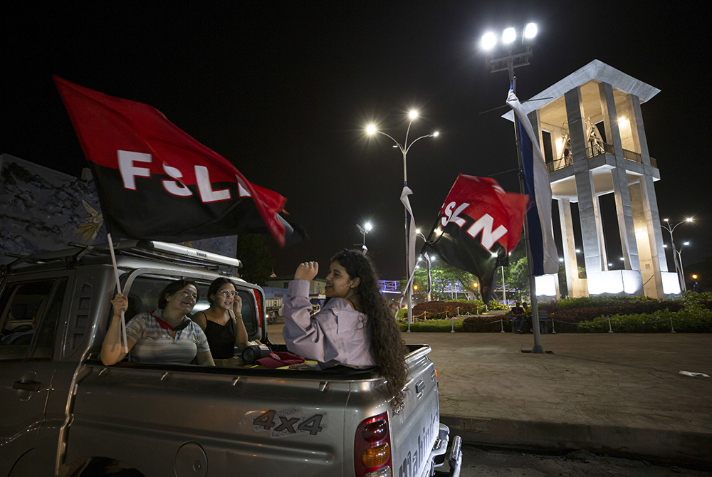 SNLF flags Nicaragua Women wave Sandinista National Liberation Front flags July 18 during commemorations for the 42nd anniversary of the triumph of the 1979 Sandinista Revolution that toppled dictator Anastasio Somoza in Managua, Nicaragua. (AP Photo/Miguel Andrés)