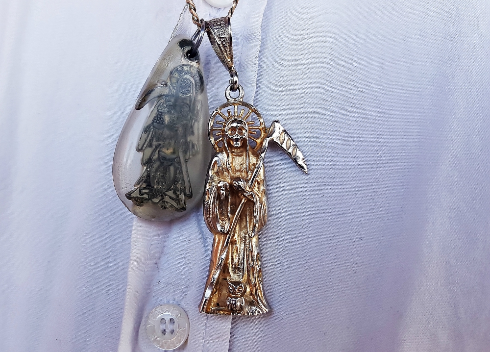 Silver pendants and other Santa Muerte paraphernalia are now popular across Mexico. (Stephen Woodman)