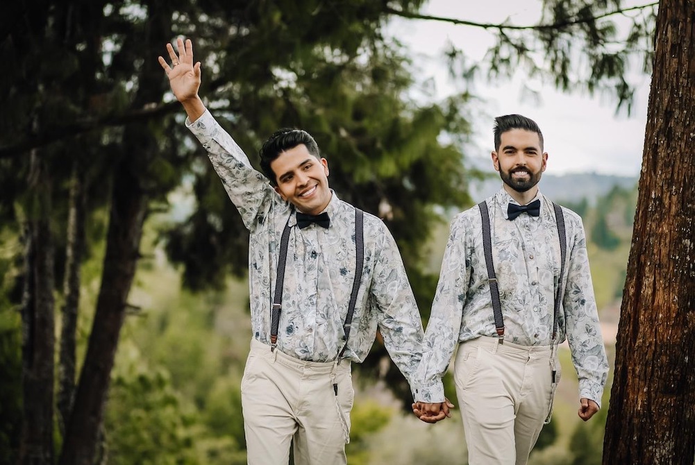 Two men walk holding hands on their wedding day in November 2020. (Juan Arango)