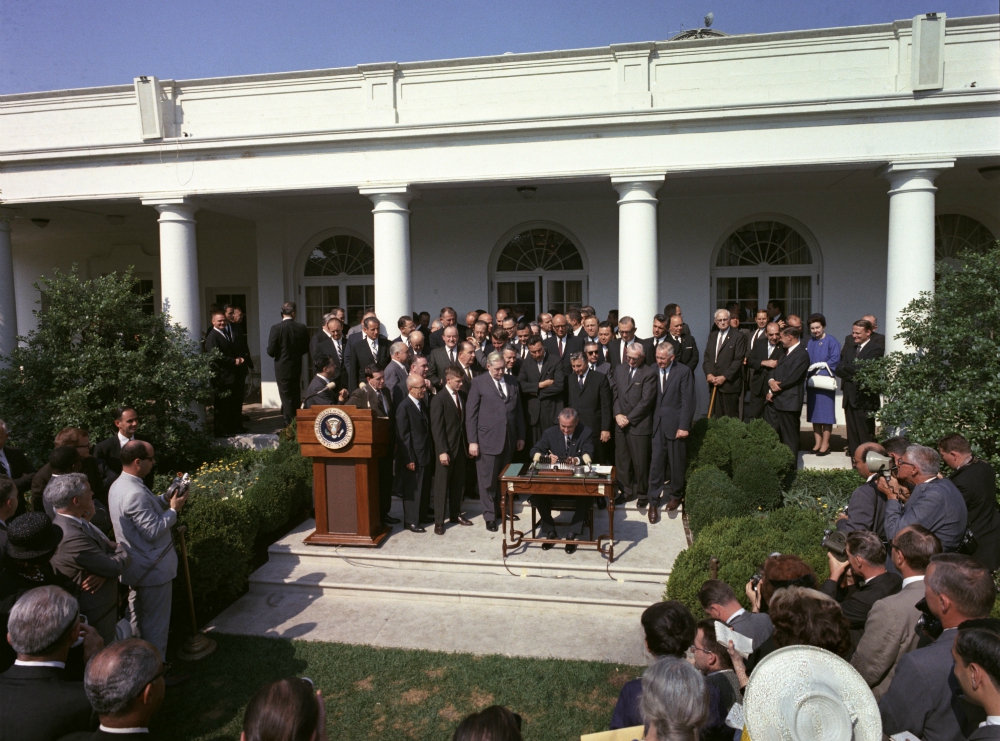 President Lyndon Johnson signs the Economic Opportunity Act, one of the War on Poverty initiatives, on Aug. 20, 1964. (Wikimedia Commons/U.S. Government)