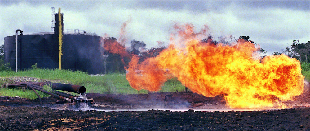 Oil waste pit fire in 1993 at a facility in Shushufindi, Ecuador, built by Texaco, which later merged with Chevron. (Courtesy of Steven Donziger)
