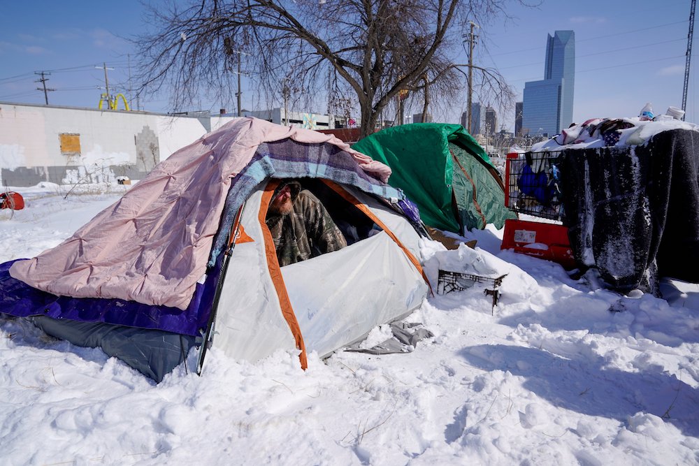 James Derrick, who is suffering from homelessness in Oklahoma City, peeks out of his tent Feb. 15, during record-breaking cold weather. (CNS photo/Nick Oxford, Reuters)