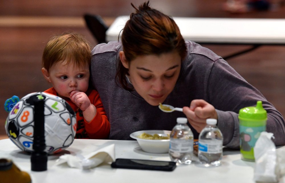 Kristen Young and her son eat soup at a warming center Feb. 15 after two days without electricity in Abilene, Texas. (CNS photo/Ronald W. Erdrich, Reporter-News, USA Today Network via Reuters)