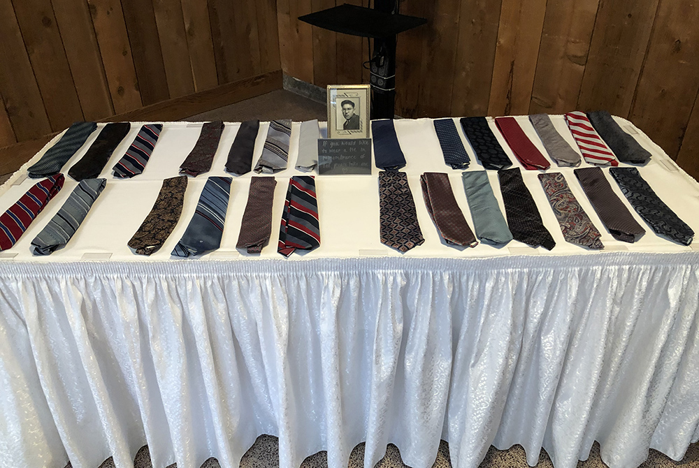 Ties that belonged to Ted George are displayed at the funeral gathering. One of the Indigenous leader's sons invited guests to carry home a tie if it "spoke" to them. (Courtesy of The Cedar Tree Institute)