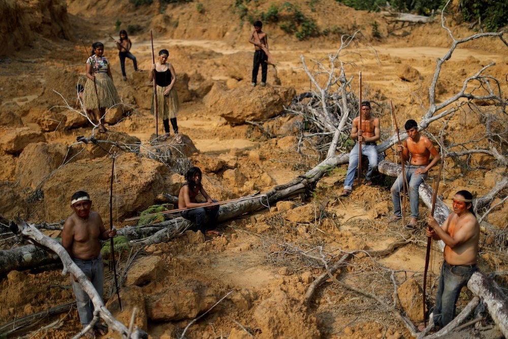 People from the Mura tribe are pictured in a file photo at a deforested area in unmarked Indigenous lands inside the Amazon rainforest near Humaitá, Brazil. In 2020, Brazil lost 2.7 million acres of the Amazon rainforest. (CNS photo/Ueslei Marcelino, Reut