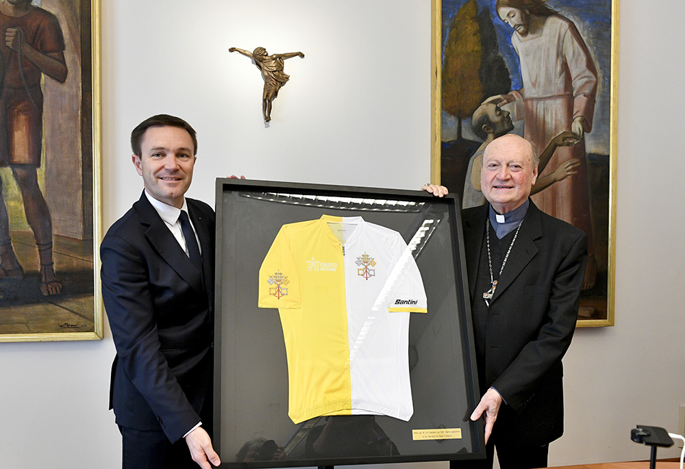 David Lappartient presents Cardinal Gianfranco Ravasi, president of the Pontifical Council for Culture, with a cycling jersey for Pope Francis during an Oct. 28 ceremony at the Vatican. (Courtesy of Athletica Vaticana)