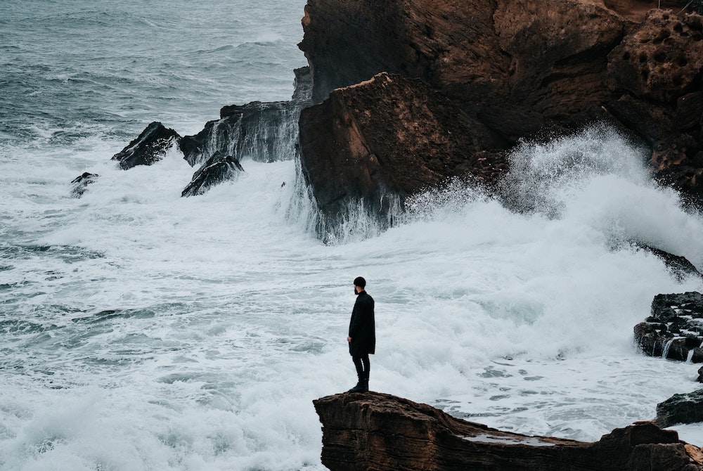 Man standing on rocky shore of Algeria (Unsplash/Benoumechiara) Man standing on rocky shore of Algeria (Unsplash/Benoumechiara)