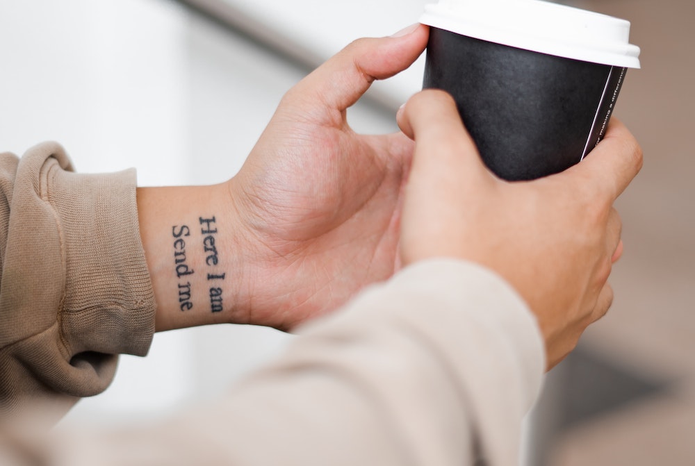 Tattoo on wrist that says "Here I am / Send me" (Unsplash/Kelli McClintock) Tattoo on wrist that says "Here I am / Send me" (Unsplash/Kelli McClintock)