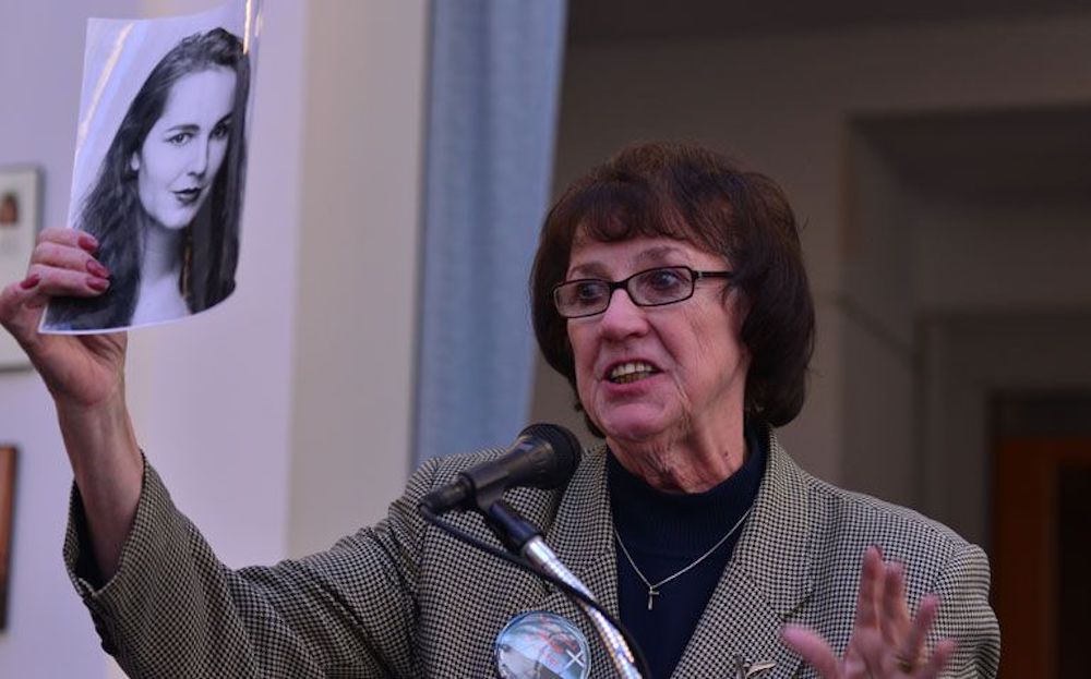 Vicki Schieber, holding a portrait of her daughter, Shannon, discusses her opposition to the death penalty during a Nov. 9, 2014, conference hosted by The Catholic University of America and the Columbus School of Law. (Newscom/ZUMA Press/Miguel Juarez Lug