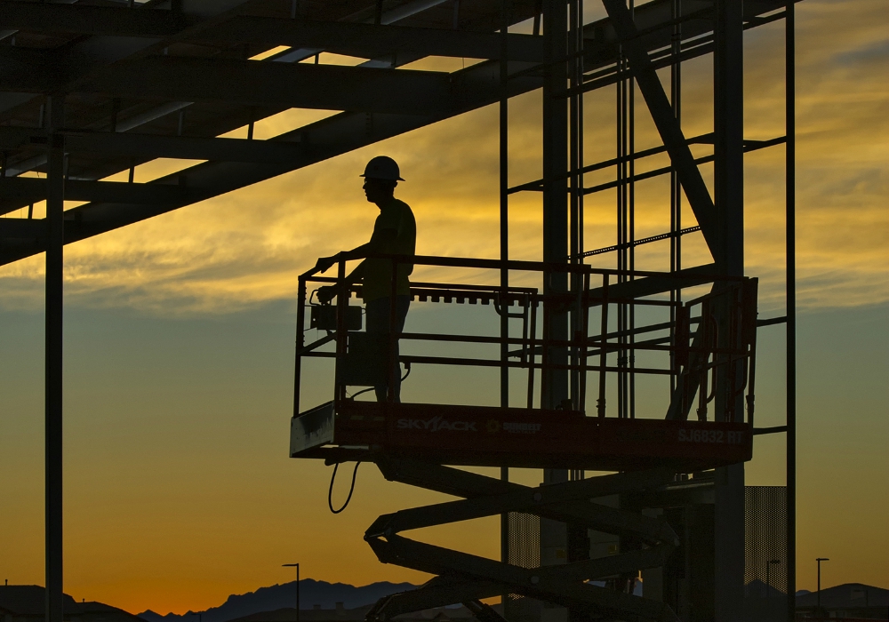 An electrician takes a lift up to 30 feet before sunrise to start string-wiring 2,700 panels on a new solar energy grid in Phoenix in November 2016. (Flickr/U.S. Department of Energy/Michael Nothum) An electrician takes a lift up to 30 feet before sunrise to start string-wiring 2,700 panels on a new solar energy grid in Phoenix in November 2016. (Flickr/U.S. Department of Energy/Michael Nothum)