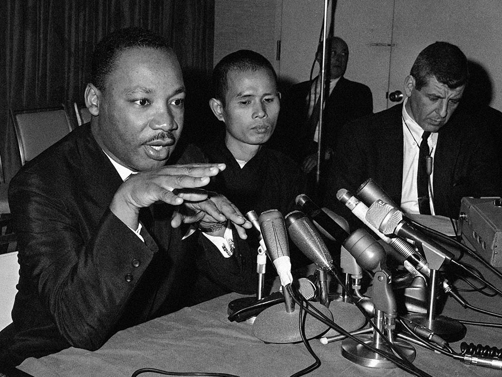 The Rev. Martin Luther King Jr. (left), in a Chicago news conference with Thích Nhất Hạnh (center), calls for a halt in bombing of Vietnam on May 31, 1966. (AP/Edward Kitch)