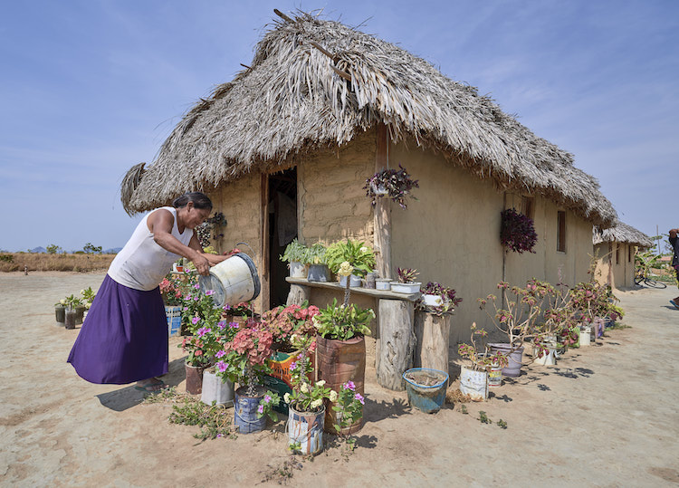 Celestina Fernandes da Silva, a Catholic activist, waters flowers in front of her home in the Wapishana indigenous village of Tabalascada, Brazil, April 3, 2019. (CNS/Paul Jeffrey)