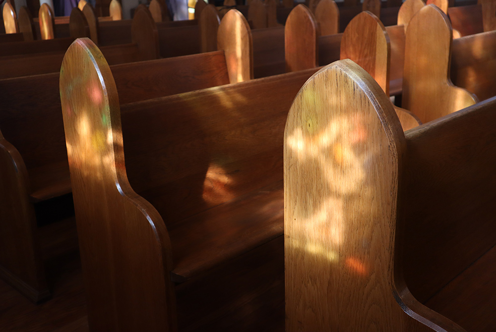 Photo illustration of church pews (Unsplash/Channel 82)