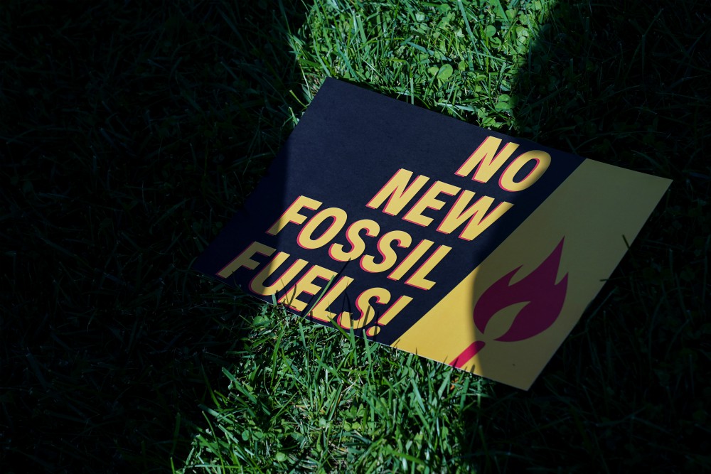 A sign protesting fossil fuels is seen on the lawn outside of the U.S. Capitol during a protest in Washington Oct. 18, 2019. (CNS/Reuters/Sarah Silbiger)